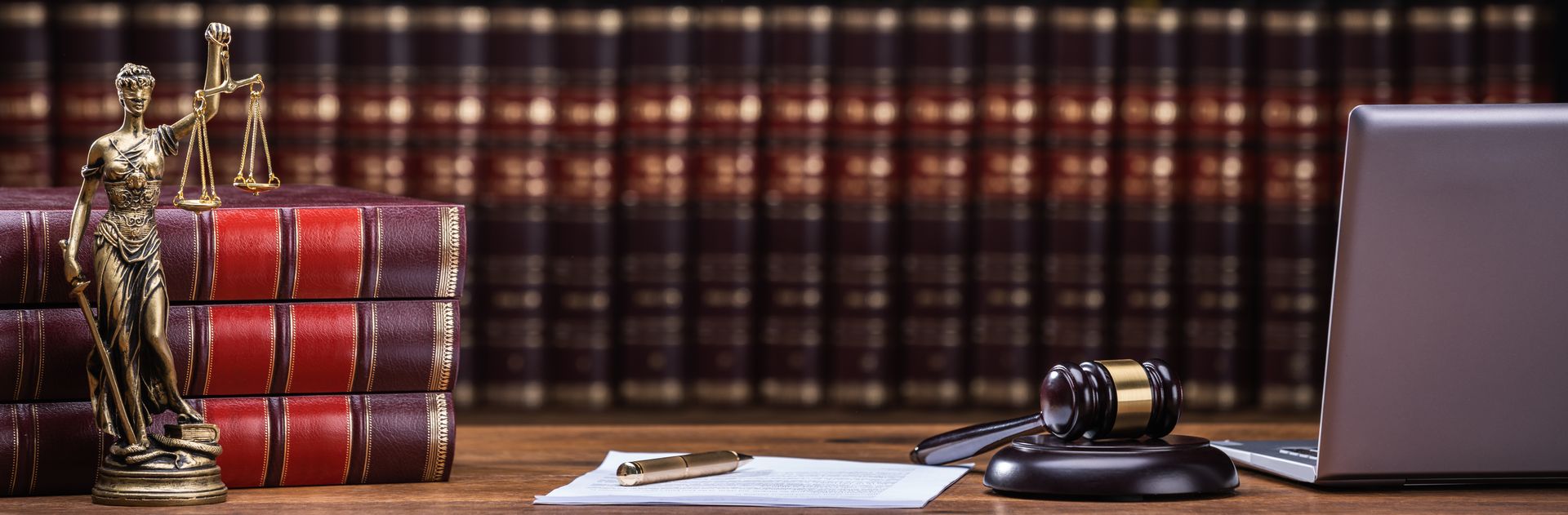 Scales of justice, law books, and a gavel on a table